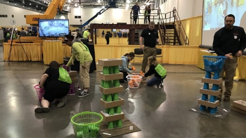 A group is stacking different colored cups